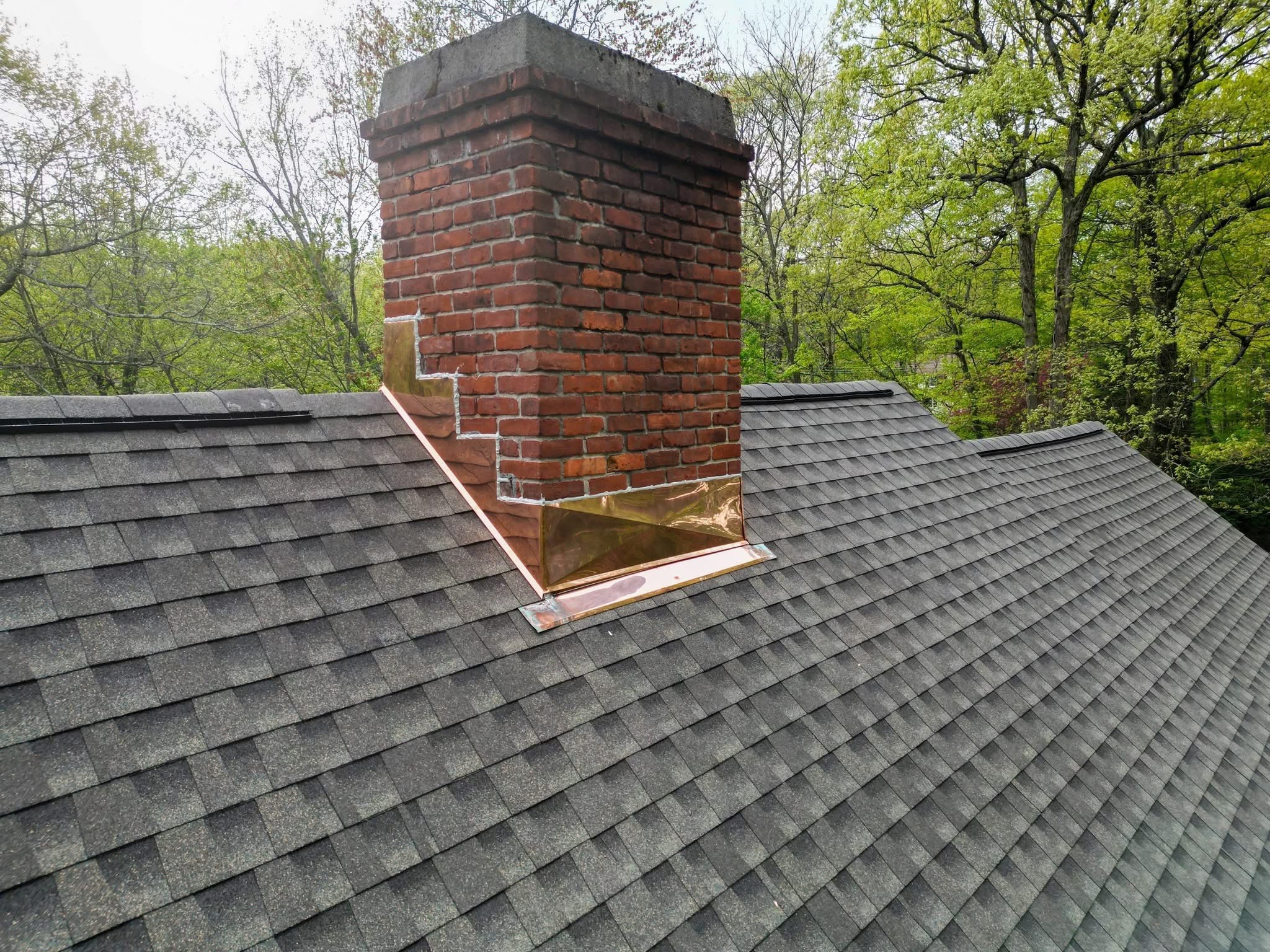 New shingle roof with chimney flashing detail
