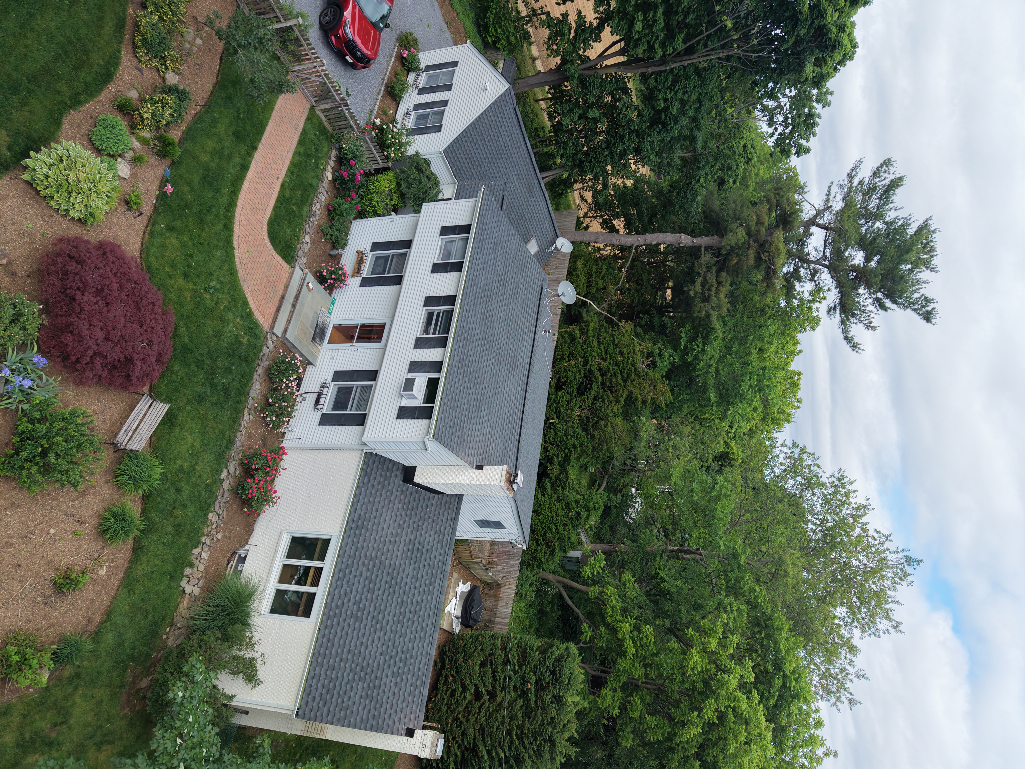Residential home with GAF architectural shingle roof and landscaped yard